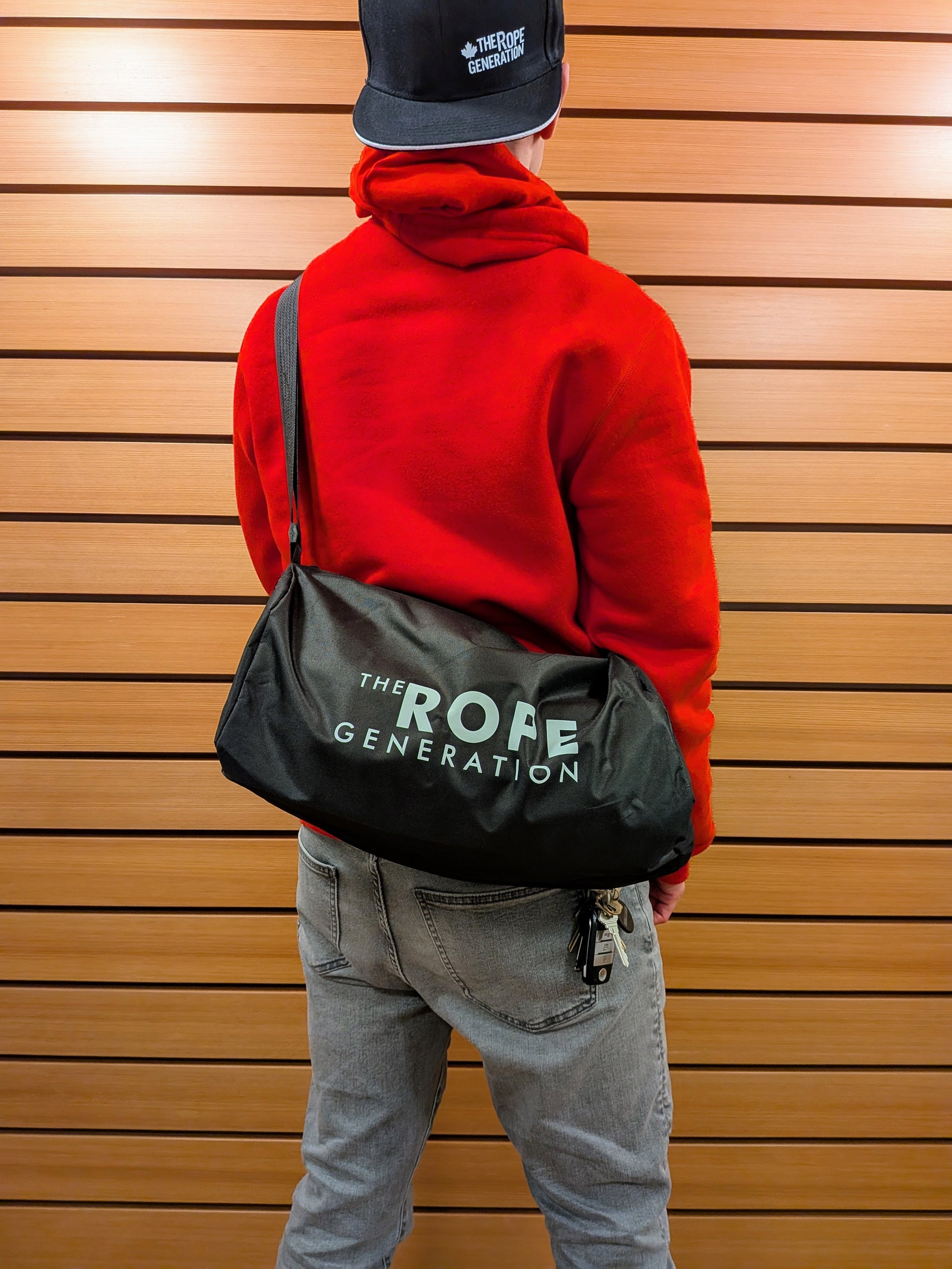 Adult carrying The Rope Generation Crossbody Duffle Bag