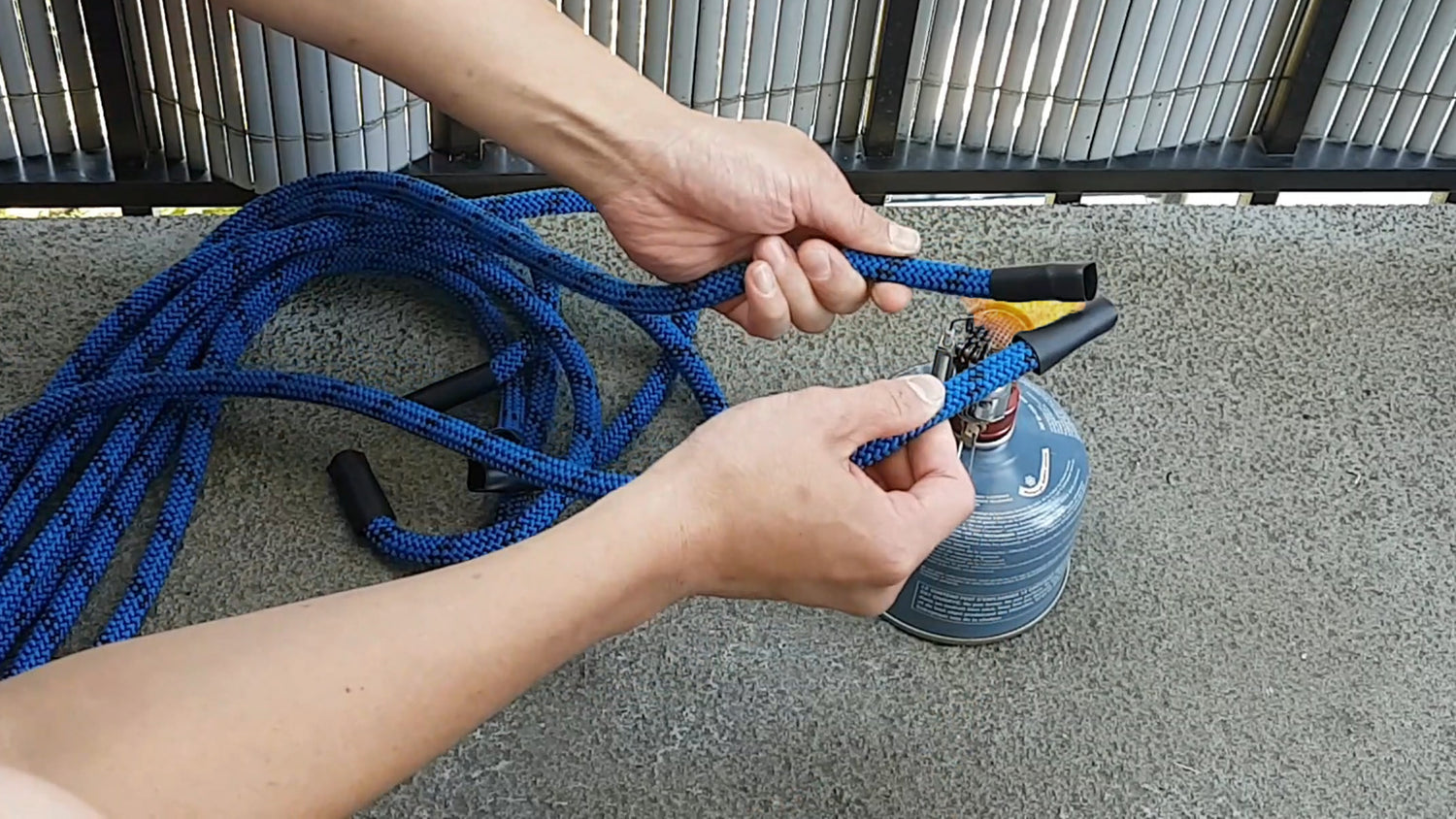 Using a gas burner to heat shrink wrap rope flow rope ends