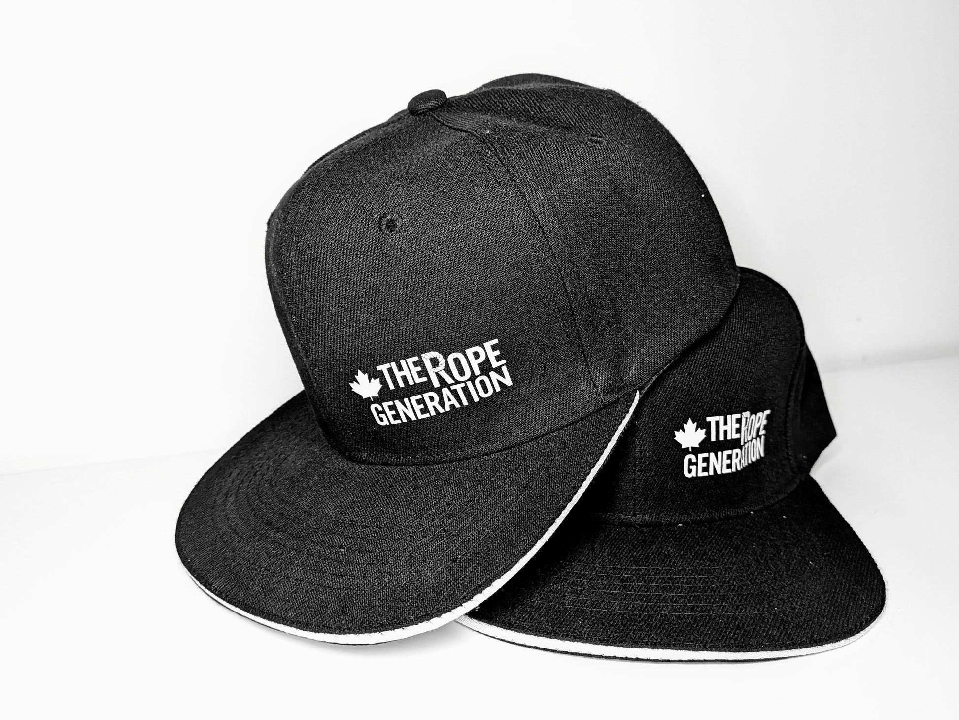Black flat brim snap back cap with the words the rope generation